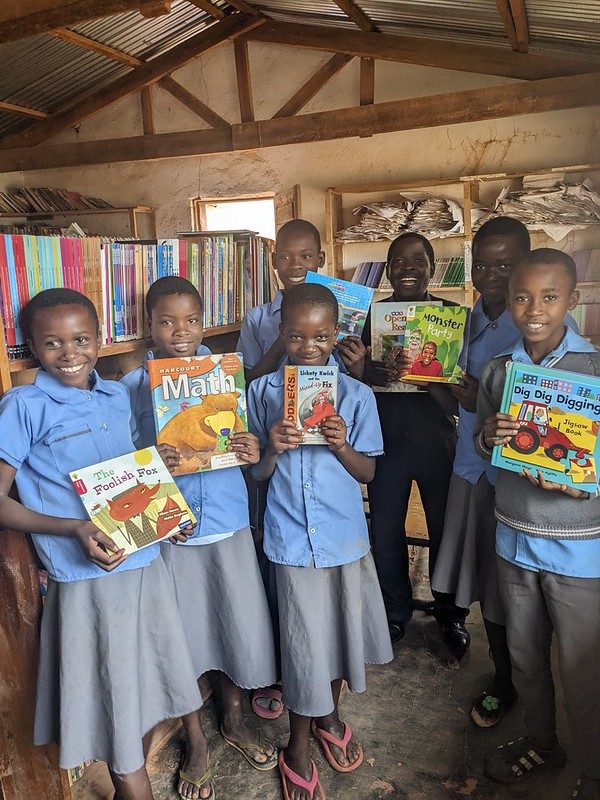 Schoolchildren in the Usisya community library, each holding a book